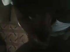 A cheap, unskilled, dark-skinned whore works on my friend's muscular penis.